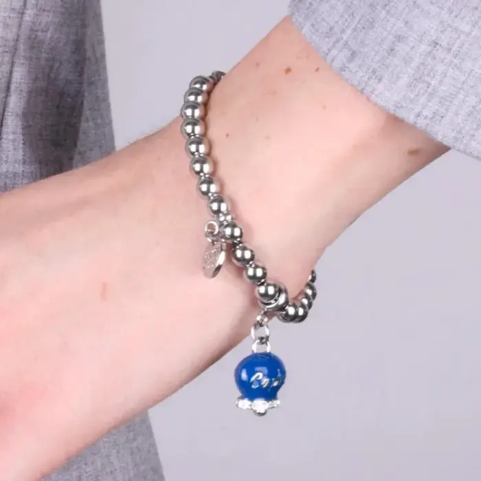 Bracciale in Acciaio con campanella pendente azzurra con scritta Capri